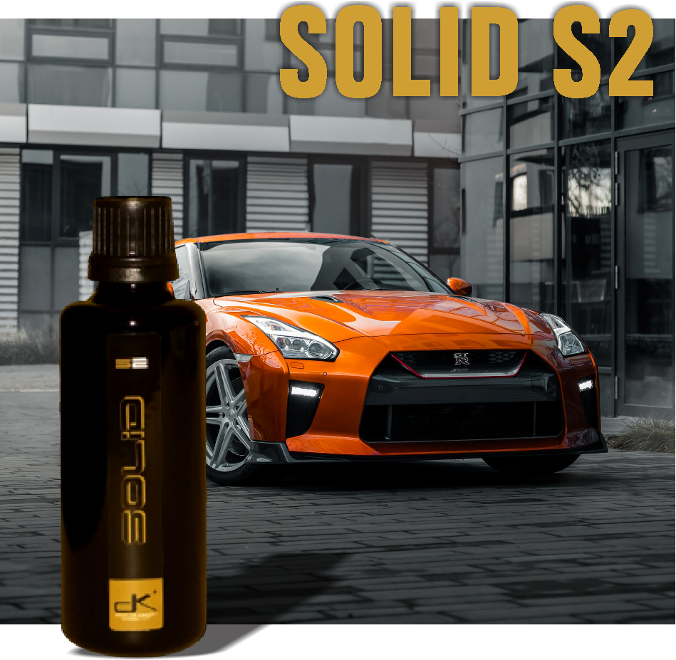 Solid S2 bottle with car in background.